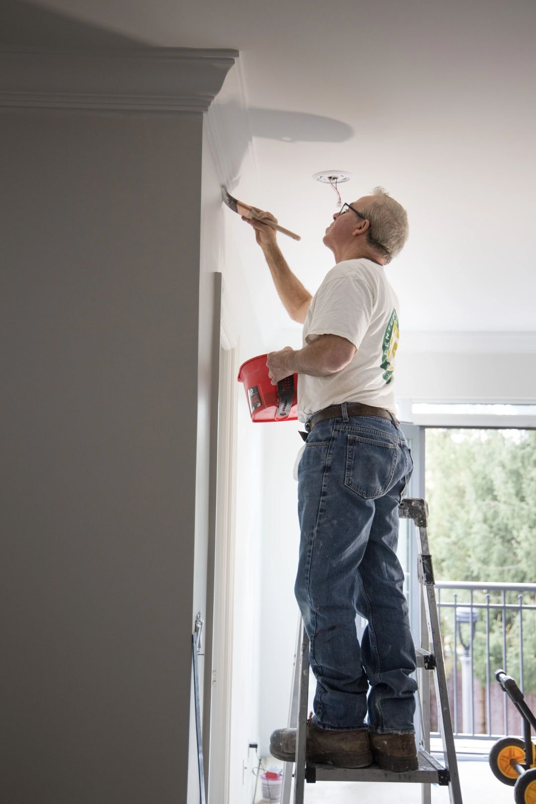 Residential renovation contractor working on interior painting and finishing project at residential property