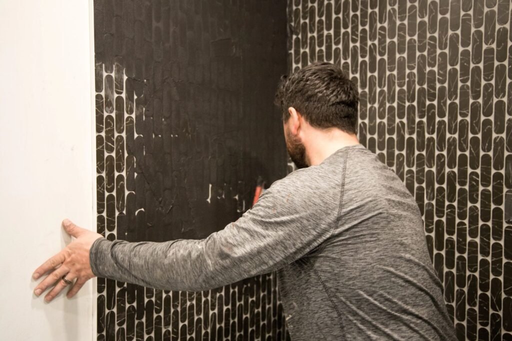 Residential renovation contractor working on interior painting and finishing project at residential property