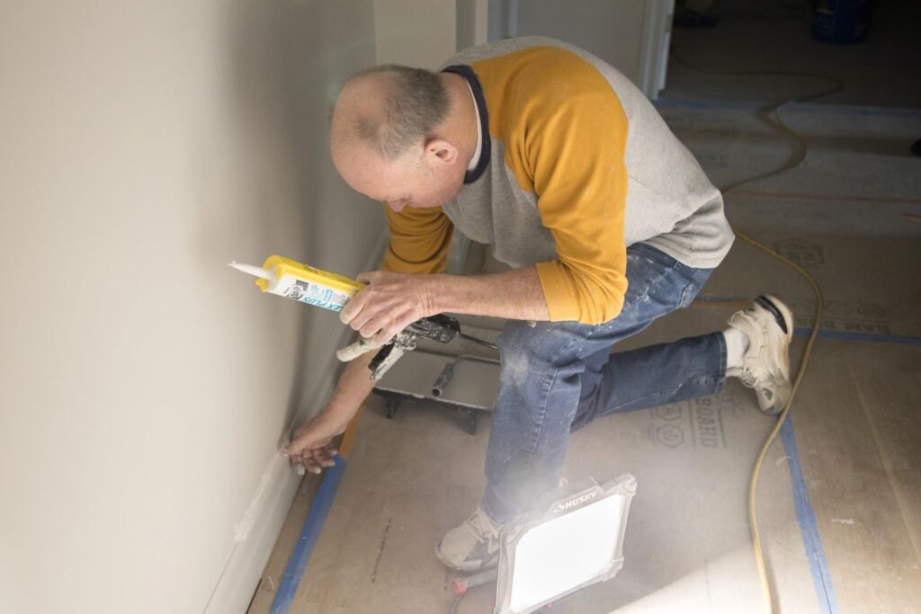Residential renovation contractor working on interior painting and finishing project at residential property
