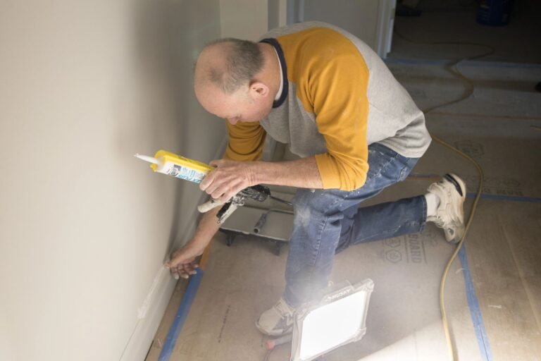 Residential renovation contractor working on interior painting and finishing project at residential property