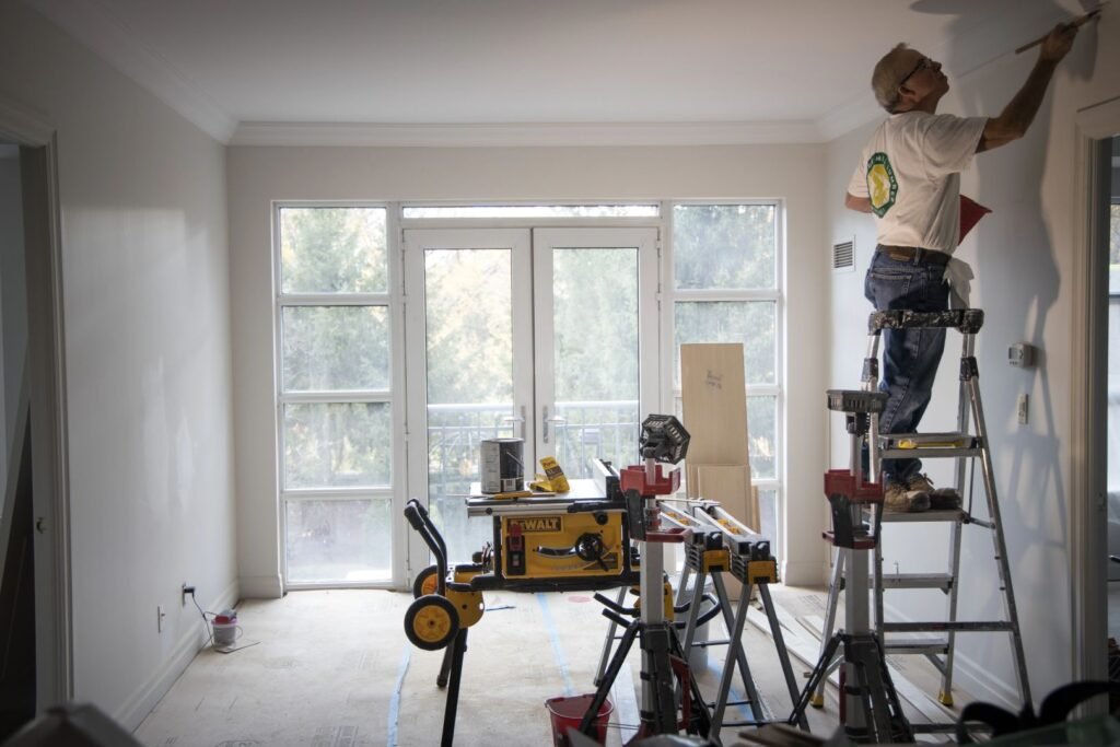 Residential renovation contractor working on interior painting and finishing project at residential property