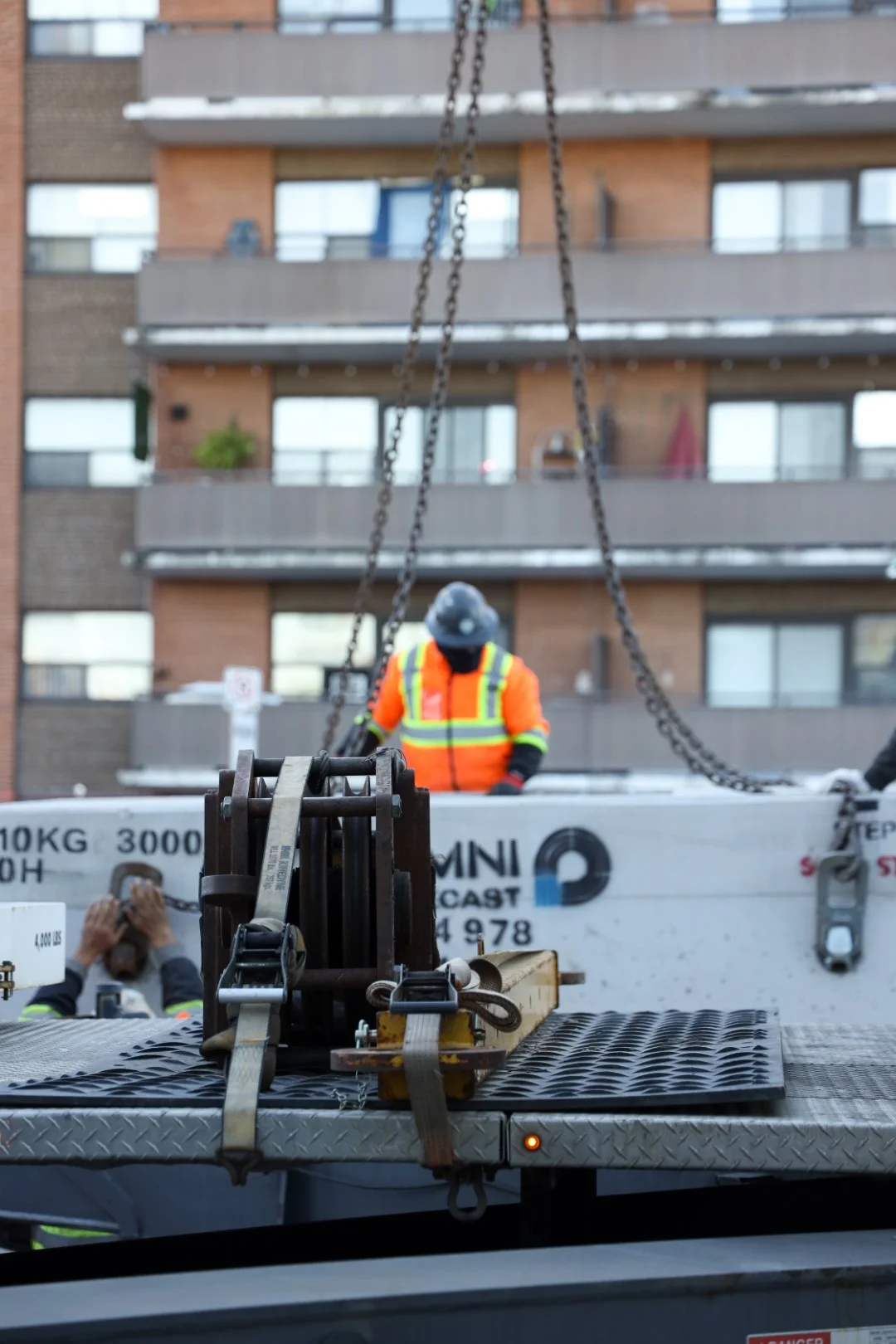 Gio Contracting Inc. sewer and watermain construction crew with heavy equipment on city street excavation