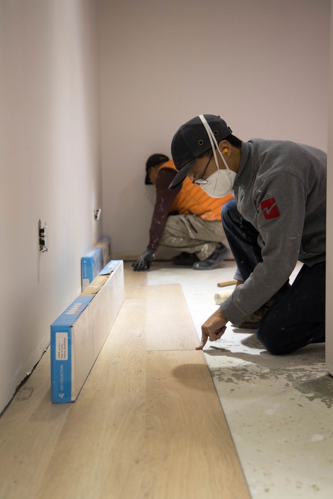 Flooring contractor working on residential floor installation